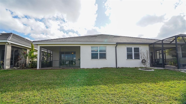 back of house featuring a lanai and a lawn