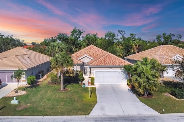 mediterranean / spanish-style house featuring a yard, a garage, and central air condition unit