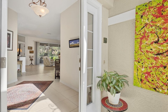 hall featuring light tile patterned flooring