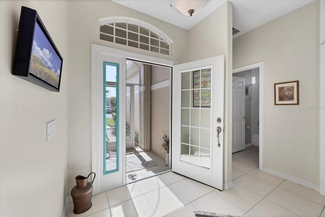 foyer entrance with light tile patterned flooring