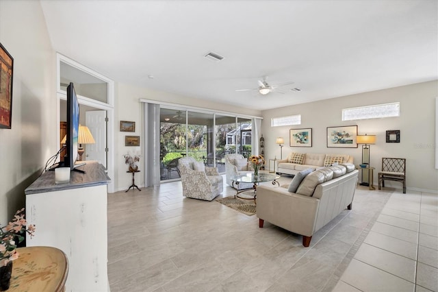 living room featuring ceiling fan and light tile patterned flooring