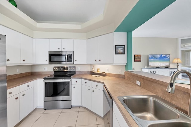 kitchen featuring sink, white cabinets, and appliances with stainless steel finishes