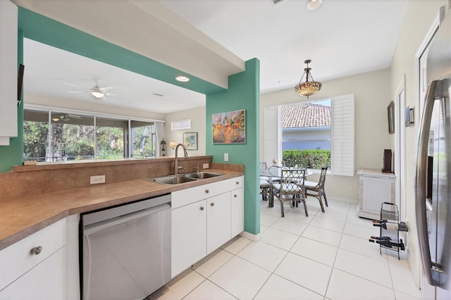 kitchen with pendant lighting, white cabinets, sink, ceiling fan, and stainless steel appliances