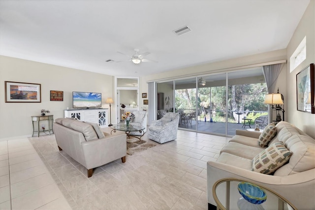 living room featuring ceiling fan and light tile patterned floors