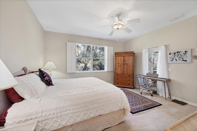 bedroom with ceiling fan and multiple windows