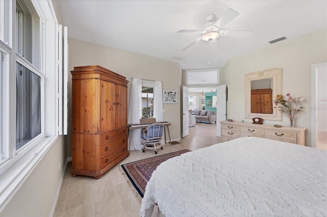 bedroom featuring light tile patterned floors and ceiling fan