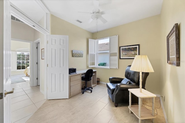 office area with light tile patterned floors and ceiling fan