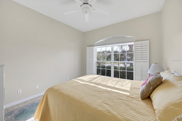 tiled bedroom featuring ceiling fan