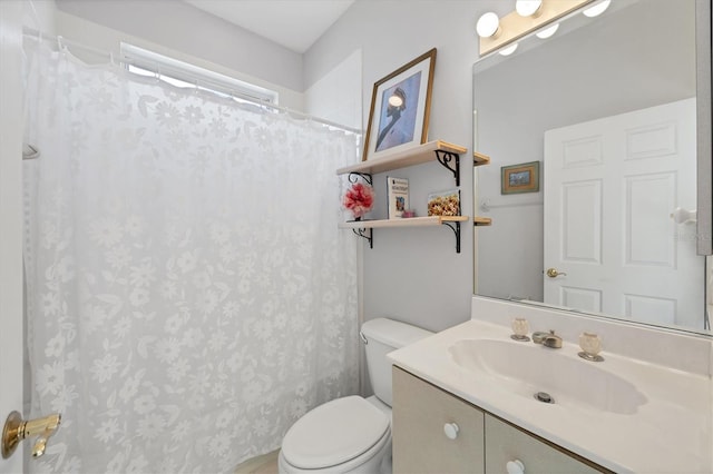 bathroom featuring vanity, toilet, and walk in shower