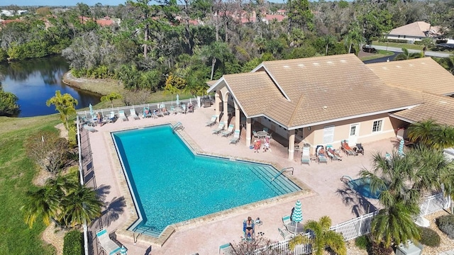 view of swimming pool featuring a patio area and a water view