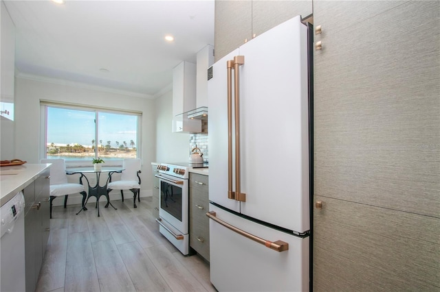 kitchen featuring white cabinetry, light wood-type flooring, white appliances, and crown molding