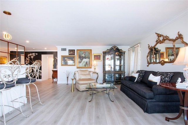 living room featuring light hardwood / wood-style floors and ornamental molding