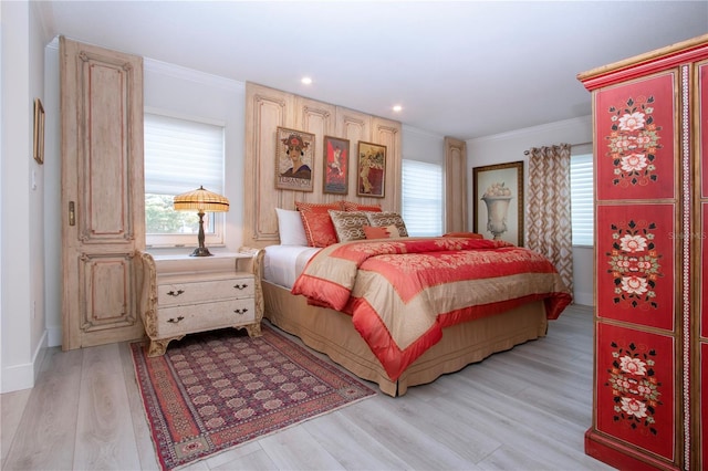 bedroom featuring light wood-type flooring and crown molding