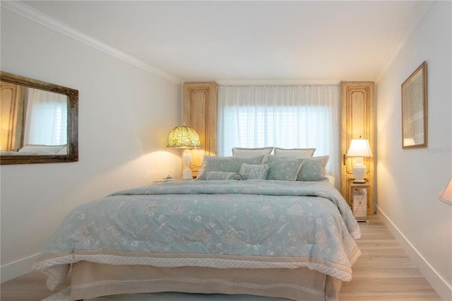 bedroom featuring light hardwood / wood-style floors and ornamental molding