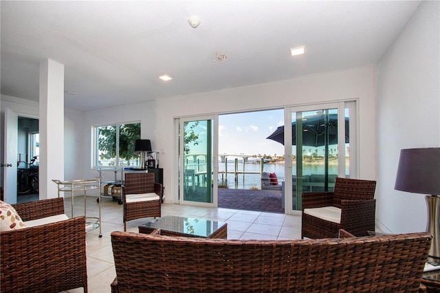 tiled living room with a water view