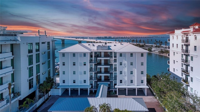 outdoor building at dusk featuring a water view