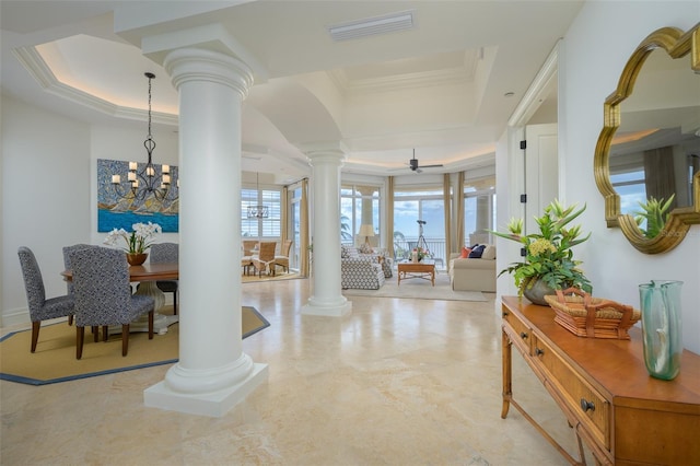 corridor with a raised ceiling, a notable chandelier, and crown molding