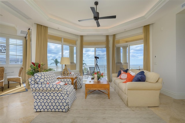 interior space with a tray ceiling and ceiling fan