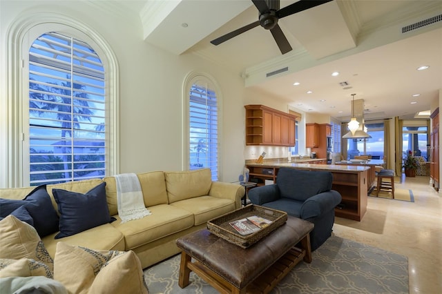 living room featuring ceiling fan and crown molding