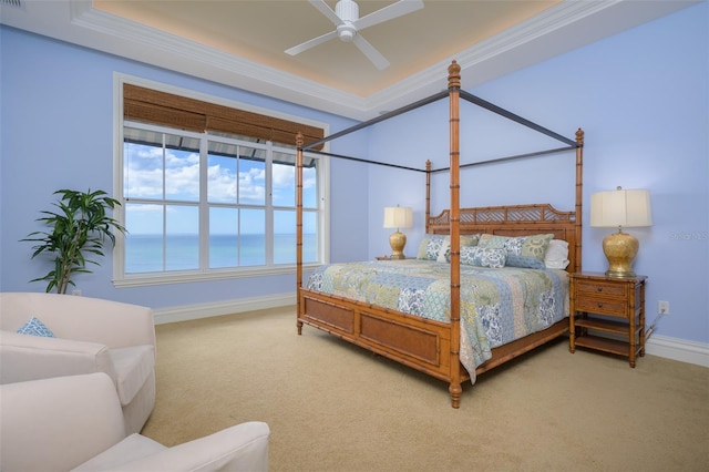 bedroom with carpet flooring, ceiling fan, a water view, and crown molding