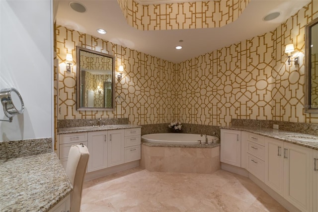 bathroom featuring tiled bath and vanity