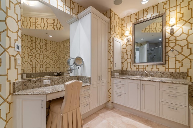 bathroom with vanity, ornamental molding, and walk in shower