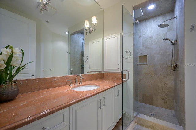 bathroom with a shower with door and vanity