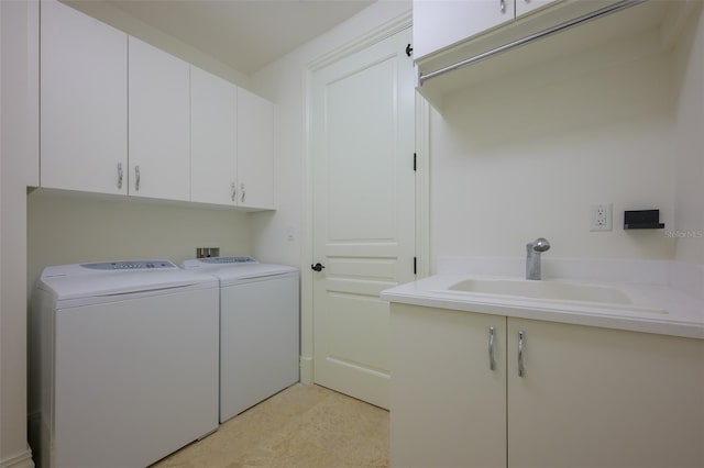 laundry room with sink, cabinets, and independent washer and dryer