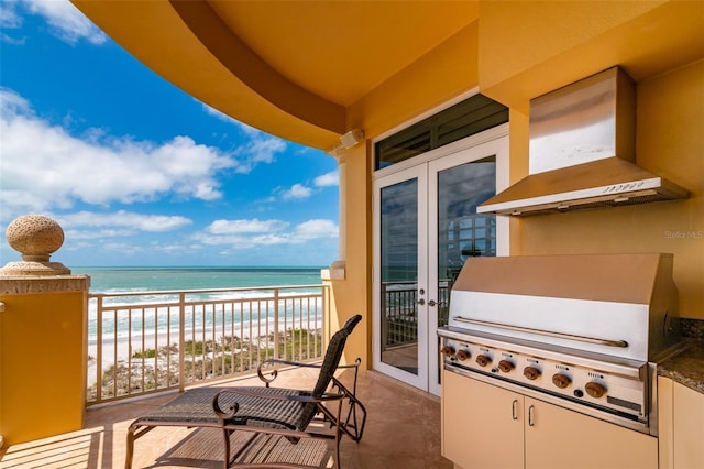 balcony with a water view, a beach view, and grilling area