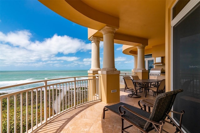 balcony with a water view and a beach view