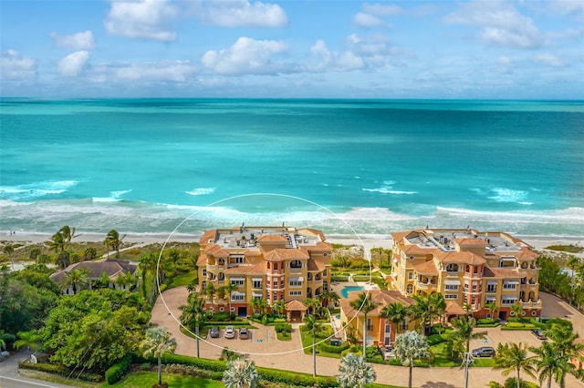 birds eye view of property with a view of the beach and a water view