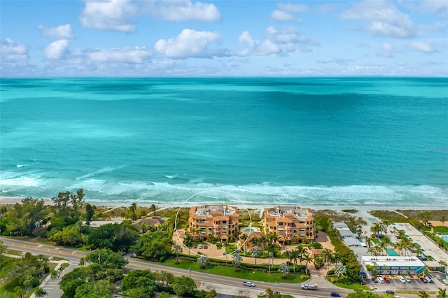 bird's eye view featuring a water view and a beach view