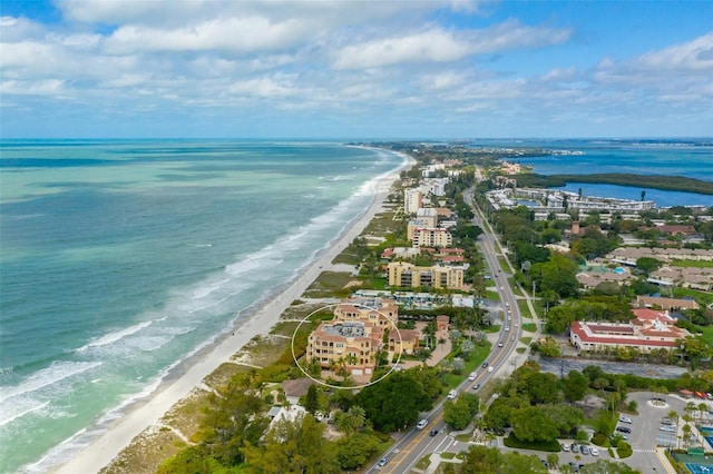 bird's eye view with a water view and a beach view