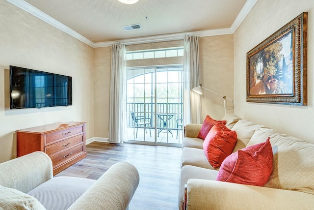 living room featuring light hardwood / wood-style floors and crown molding