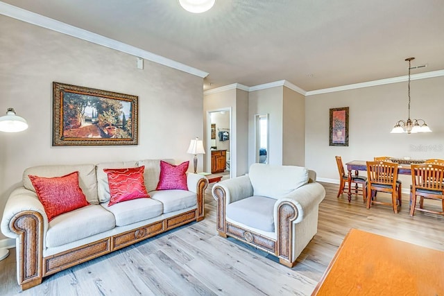 living room featuring crown molding, an inviting chandelier, and light wood-type flooring