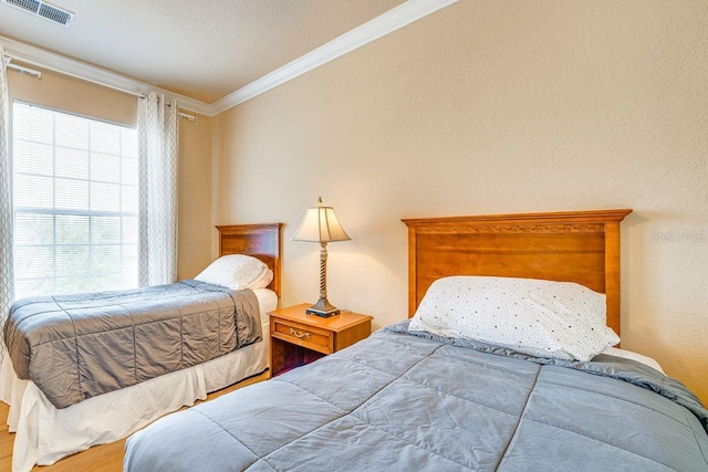 bedroom featuring hardwood / wood-style flooring and ornamental molding