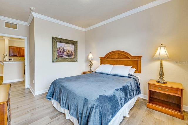 bedroom featuring crown molding and light hardwood / wood-style floors