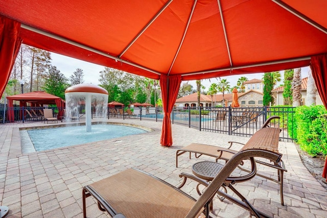 view of pool with a gazebo, a patio area, and pool water feature