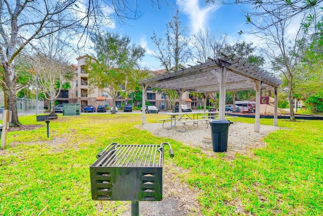 view of community featuring a pergola and a lawn