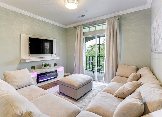 1301 Tuscan Ter Unit 9401, Davenport, FL 33896 - living area featuring wood finished floors, crown molding, and a glass covered fireplace