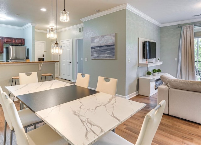 1301 Tuscan Ter Unit 9401, Davenport, FL 33896 - dining space with light wood finished floors, ornamental molding, a chandelier, and recessed lighting