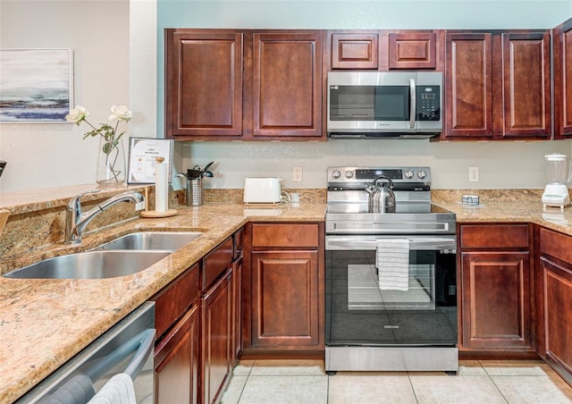 1301 Tuscan Ter Unit 9401, Davenport, FL 33896 - kitchen with appliances with stainless steel finishes, light stone counters, and light tile patterned flooring
