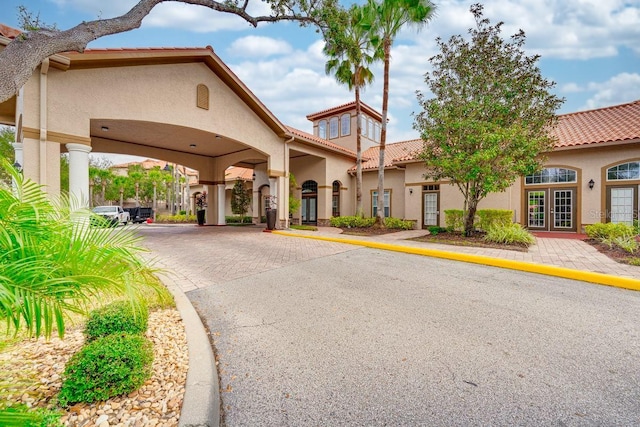 1301 Tuscan Ter Unit 9401, Davenport, FL 33896 - view of front of house featuring stucco siding, french doors, a tile roof, and decorative driveway