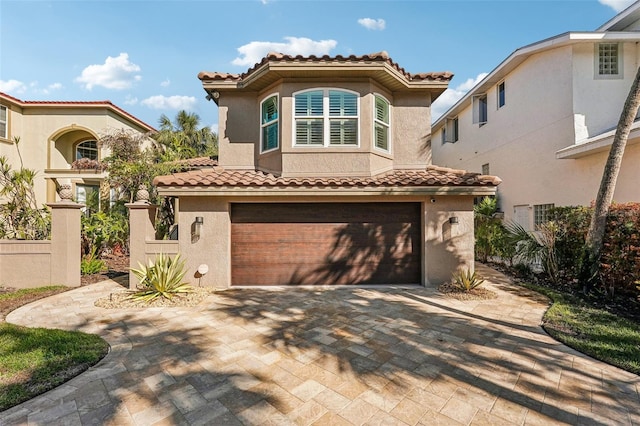 mediterranean / spanish-style home with a garage