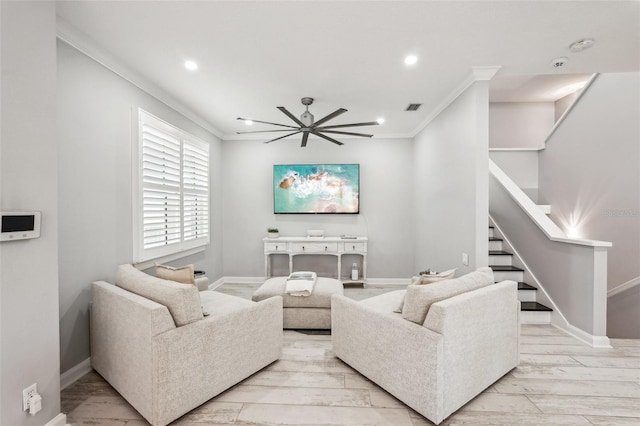 living room featuring light hardwood / wood-style flooring, ceiling fan, and ornamental molding