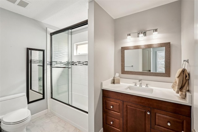 full bathroom featuring vanity, enclosed tub / shower combo, and toilet