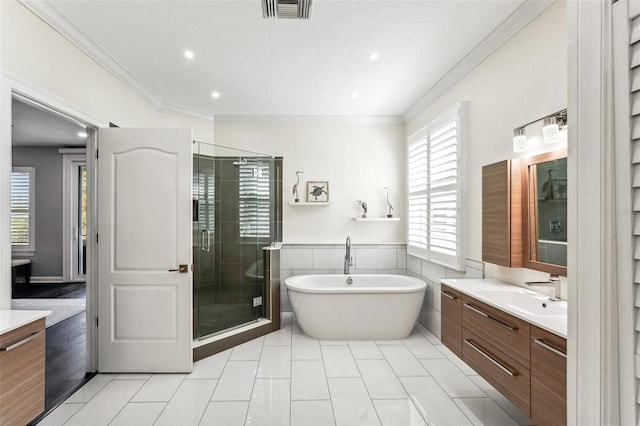 bathroom featuring tile patterned flooring, vanity, ornamental molding, and shower with separate bathtub