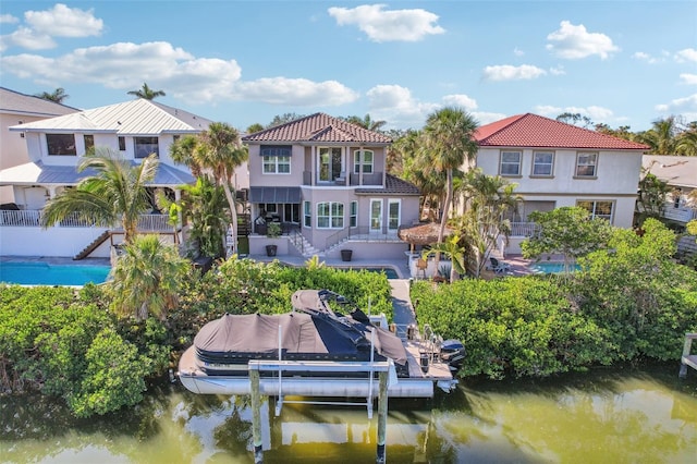 exterior space featuring a water view and a balcony