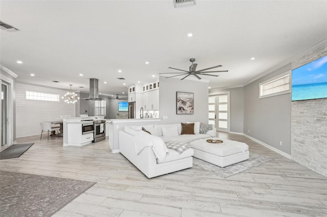 living room with ceiling fan, light hardwood / wood-style floors, sink, and crown molding