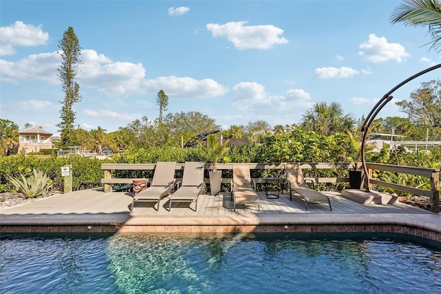 view of swimming pool featuring a water view